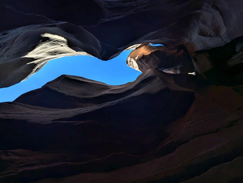 Looking up through a slot canyon at the sky